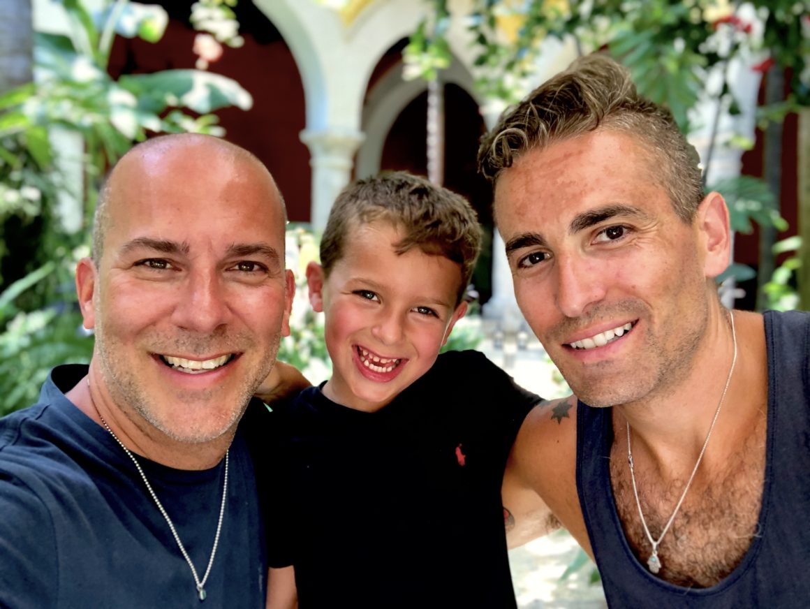 Frank, Milo and BJ all smiling with palm trees and arch ways in the background.